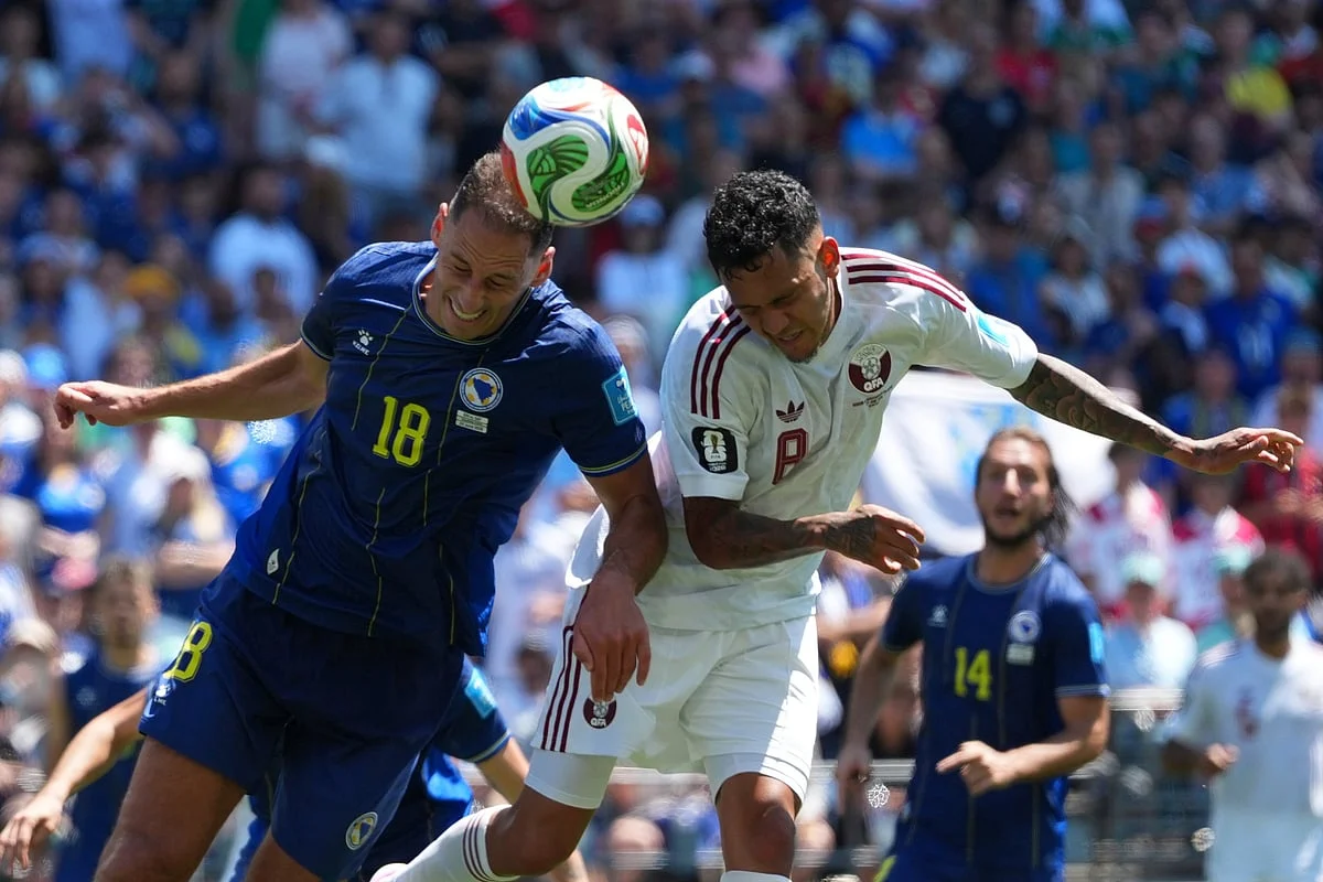Bosnia and Herzegovina players celebrate Arjan Alajbegovic's opening goal against Qatar at Lumen Field in Seattle